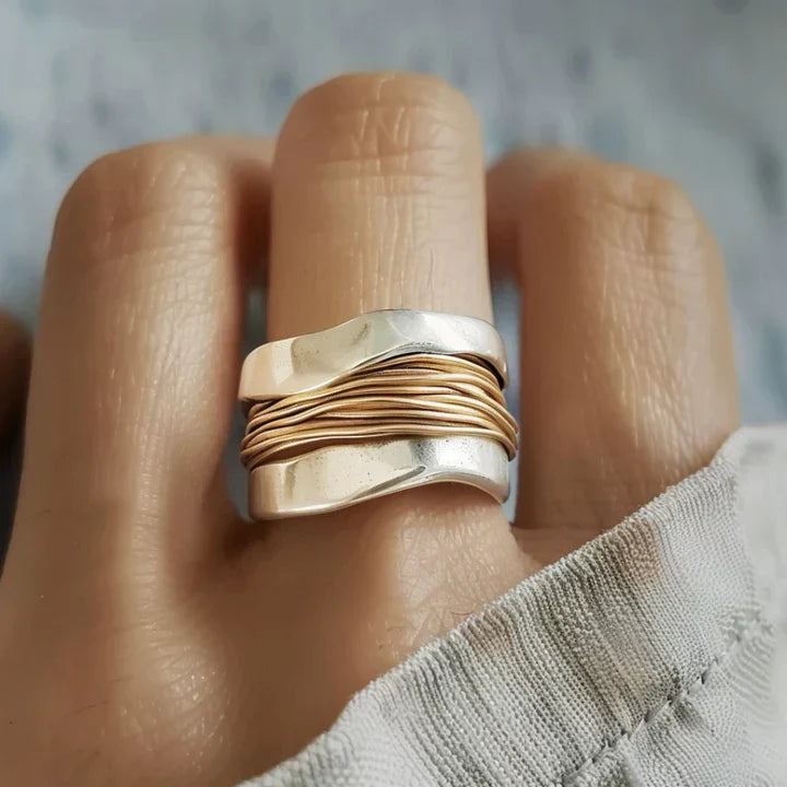 Silver ring with golden threads.